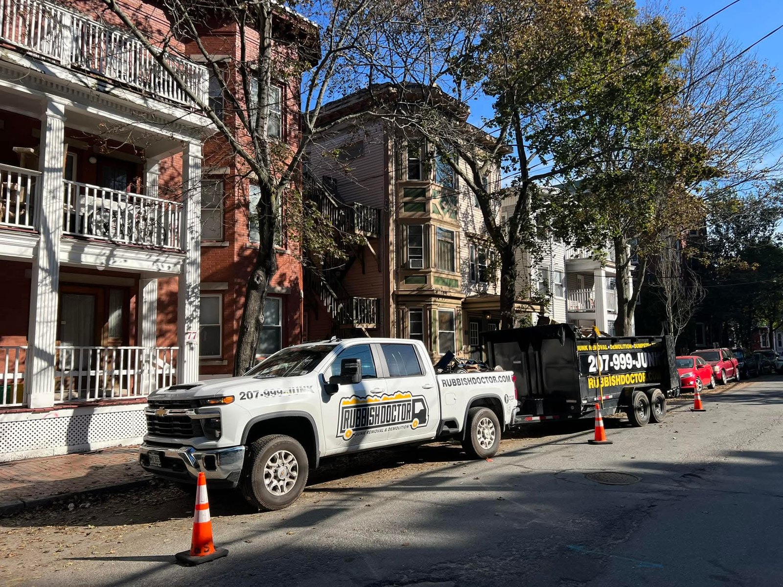 Rubbish Doctor truck delivering a dumpster at a home